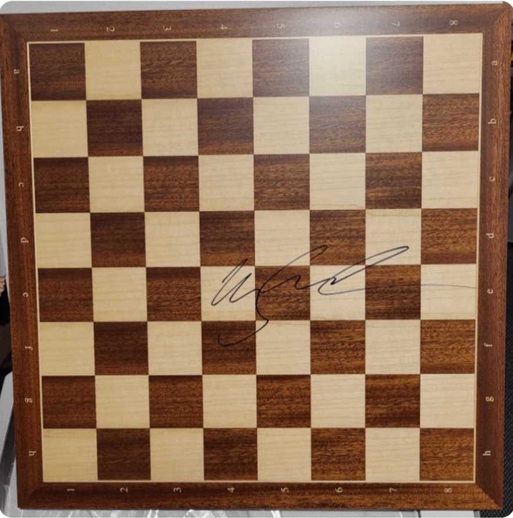 A chessboard signed by Magnus Carlsen - the prize in Advent of Chess
