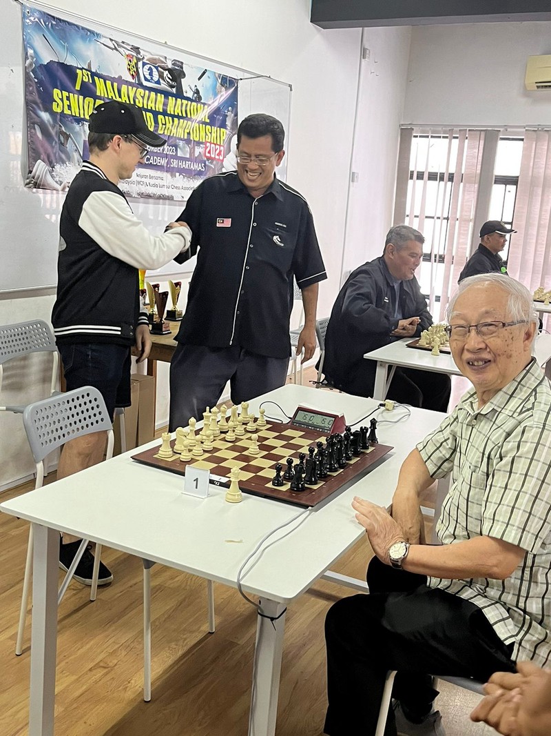 Me (left) meeting IO Amirul Haji Mohamad (middle), International Organizer and National Arbiter from Kuala Lumpur, Malaysia and participants of the 1st Malaysian National Rapid Chess Championship