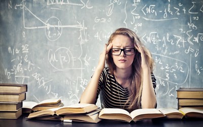 Woman studying books and thinking hard