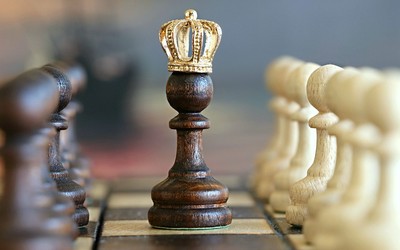 Chess pawn with golden crown.