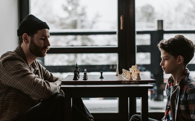 A man and a boy playing chess