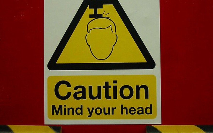A sign warning the viewer: "Caution. Mind your head."